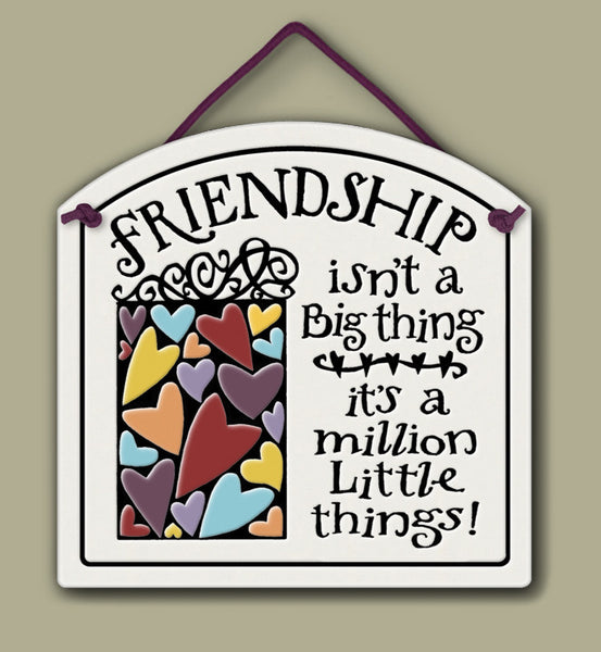 Ceramic wall tile with colorful heart illustration and the quote ‘Friendship isn’t a big thing, it’s a million little things.’