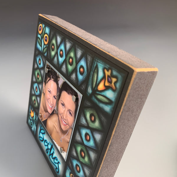 Corner detail of Besties picture frame featuring stained glass inspired floral artwork and geometric diamond pattern by Michael Macone