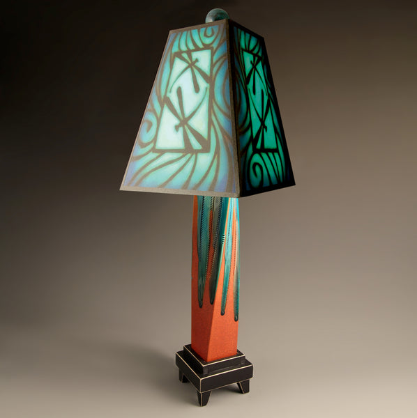 Blue Dragonfly handmade ceramic table lamp with twisted red extruded clay base, bold dragonfly art shade glowing in teal and blue by Michael Macone, made in Shell Lake Wisconsin
