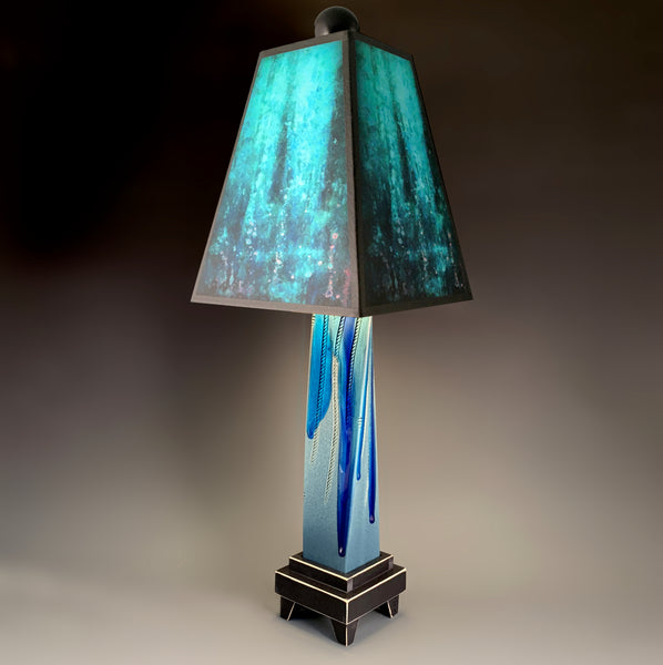 Blue Rain handmade ceramic table lamp with twisted blue extruded clay base, deep layered blue glowing shade by Macone Clay, made in Shell Lake Wisconsin