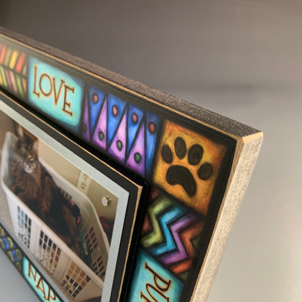 Corner detail of cat picture frame showing colorful stained glass style Michael Macone artwork and wood frame construction.