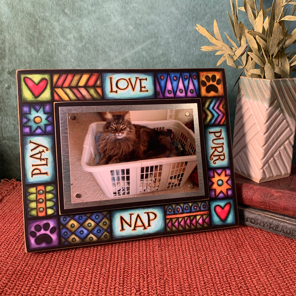 Cat picture frame with quote Love Purr Nap Play displayed on a shelf featuring colorful Michael Macone artwork and magnetic 4 x 6 photo display.