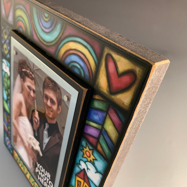 Corner detail of wedding picture frame artwork featuring colorful Michael Macone illustration surrounding the quote And they lived happily ever after.