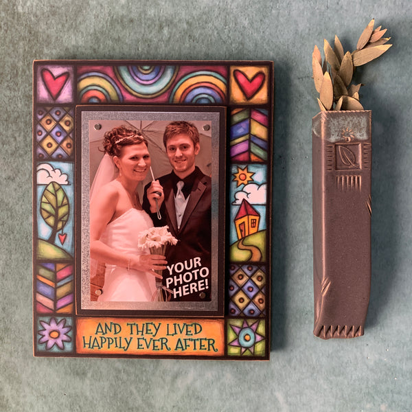 Wedding picture frame wall display featuring the quote And they lived happily ever after with bright artwork surrounding a 4x6 photo.