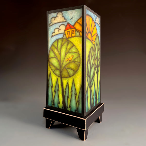 House on Hill mood lamp glowing with whimsical countryside paper shade