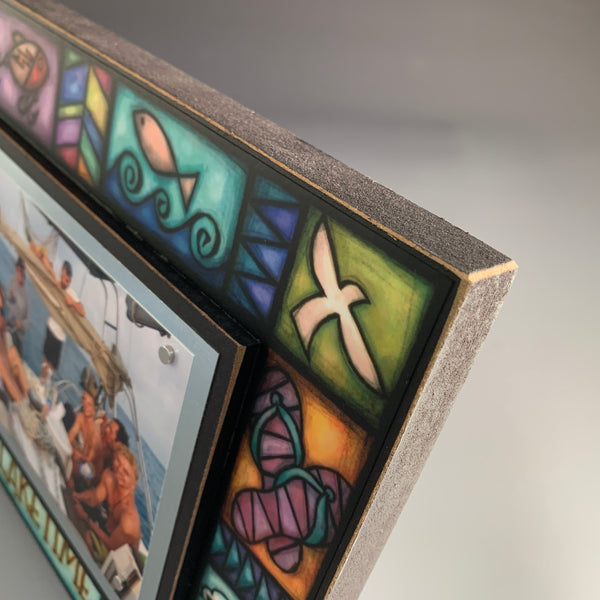 Corner detail of Laketime lake picture frame showing colorful lake themed artwork including fish, dragonfly, and lake life motifs