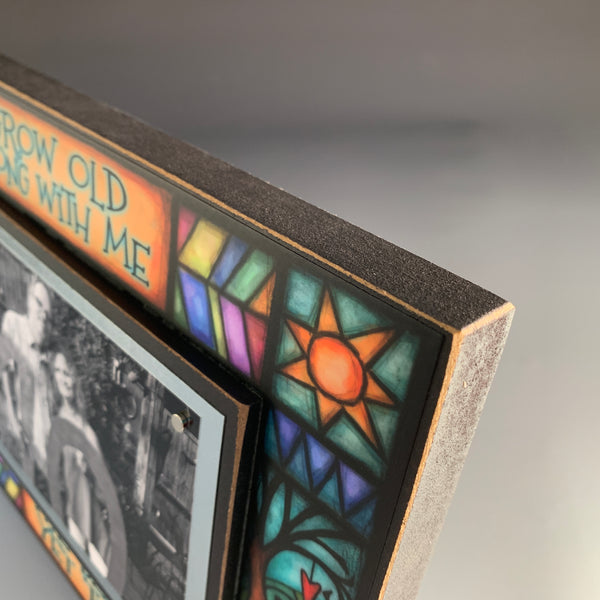 Top corner detail of Macone Clay anniversary picture frame featuring colorful Michael Macone artwork and wood frame edge