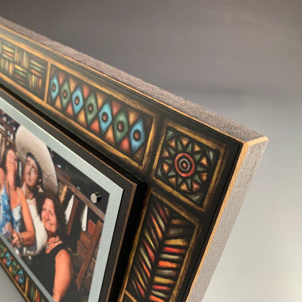 Top corner detail of Brown Motif picture frame featuring Michael Macone artwork with geometric pattern and wood frame craftsmanship