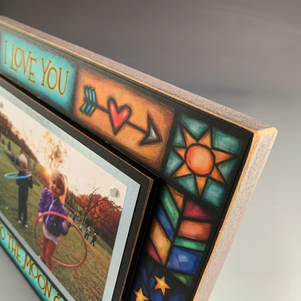 Top corner detail of I Love You To The Moon And Back picture frame featuring Michael Macone artwork and wood craftsmanship