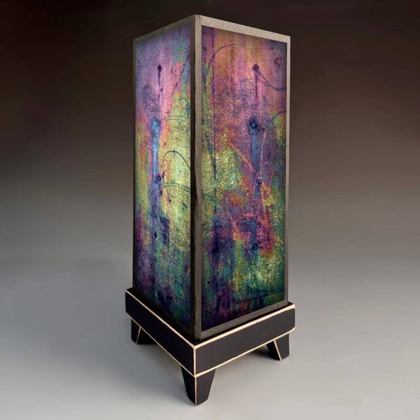 Metallic Glass mood lamp glowing with abstract iridescent paper shade