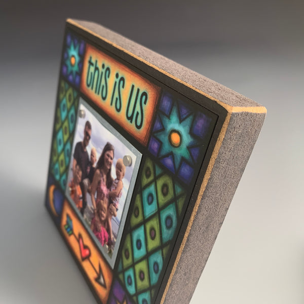 Close up detail of This Is Us picture frame showing Michael Macone artwork and wood craftsmanship, Macone Clay