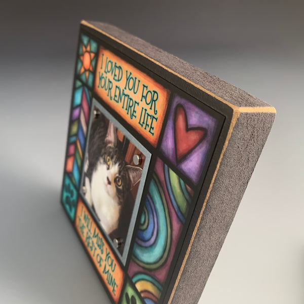 Corner detail of pet memorial picture frame featuring colorful Michael Macone artwork with comforting patterns and paw print accents