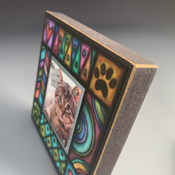 Corner detail of pet picture frame with paw print design featuring colorful Michael Macone artwork with hearts and playful pet themed elements