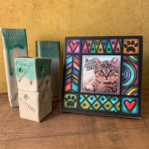 Pet picture frame with paw print design displayed on shelf, Michael Macone artwork with colorful patterns and magnetic photo display for pet lovers