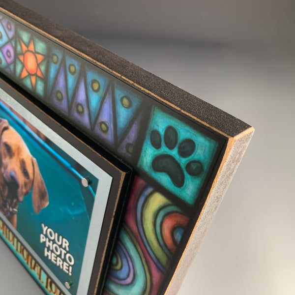 Corner detail of pet picture frame showing colorful stained glass style Michael Macone artwork and wood frame construction.