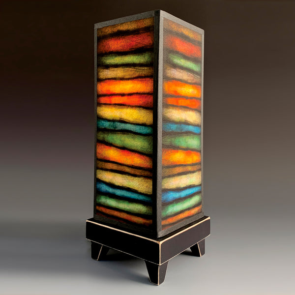 Rough Stripes mood lamp glowing with painterly striped paper shade