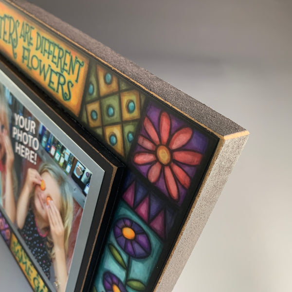Corner detail of sisters picture frame featuring colorful floral patterns and decorative artwork by Michael Macone