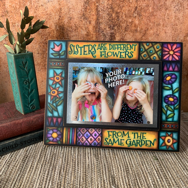 Sisters picture frame sister gift displayed on shelf with quote Sisters are different flowers from the same garden artwork by Michael Macone