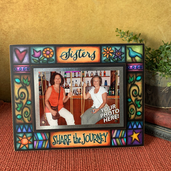 Sisters Share the Journey quote picture frame displayed on shelf with family photo, colorful Michael Macone artwork and magnetic 4 x 6 photo holder