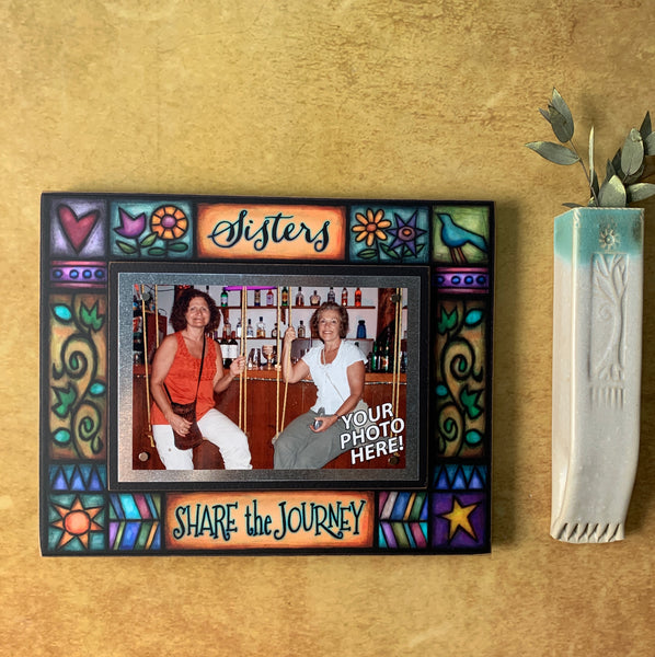 Sisters Share the Journey quote picture frame hanging on wall with photo, colorful Michael Macone artwork and magnetic 4 x 6 picture display