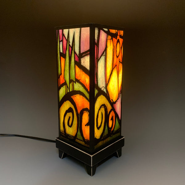 Tree Hill mood lamp lit with room lights off, showing warm sunset glow