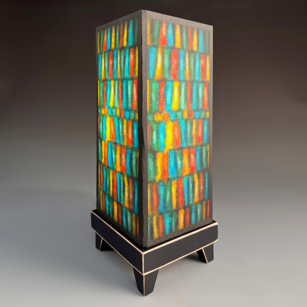 Vertical Stripes mood lamp glowing with colorful striped paper shade