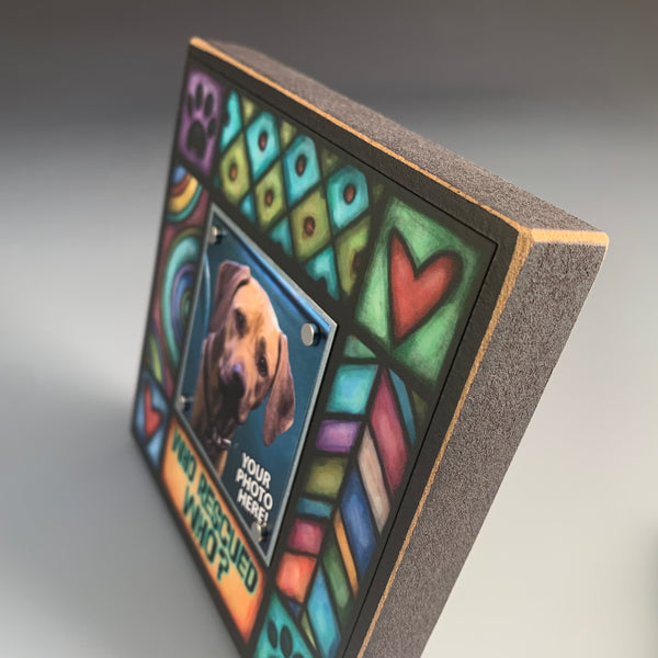 Corner detail of Who rescued who pet picture frame highlighting colorful Michael Macone artwork with paw prints and hearts design